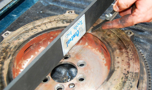 Using a straight edge and feeler gauge is another effective way to determine if there is runout on flywheel surfaces.
