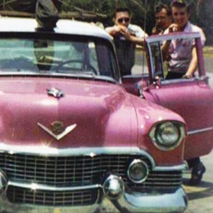 A rare picture of Elvis and band members with the original pink Cadillac he owned. This 1954 Fleetwood was the first Cadillac he purchased, and it was lost due to vehicle fire soon after. He later purchased a 1955 model that was custom painted to match this one. The '55 is the one he held onto, and the one everyone remembers him by.