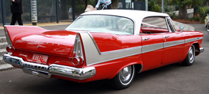 Rear view of a white-over-red 1958 Plymouth Fury hardtop sedan, similar to the one in the book.