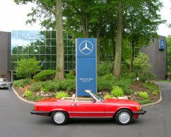 red 1988 Mercedes 107