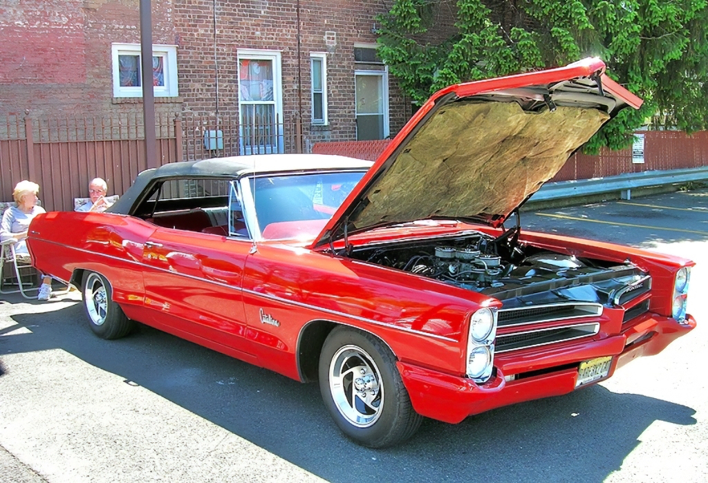 A 1966 Pontiac Catalina convertible, with customized color-matching bumpers.