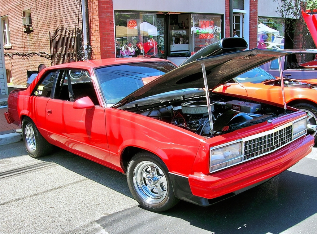 A 1980 Chevrolet Malibu coupe, retrofitted with a front end clip from a later 1982-83 model (coupes were not offered after ’81). Headlights are further customized also.