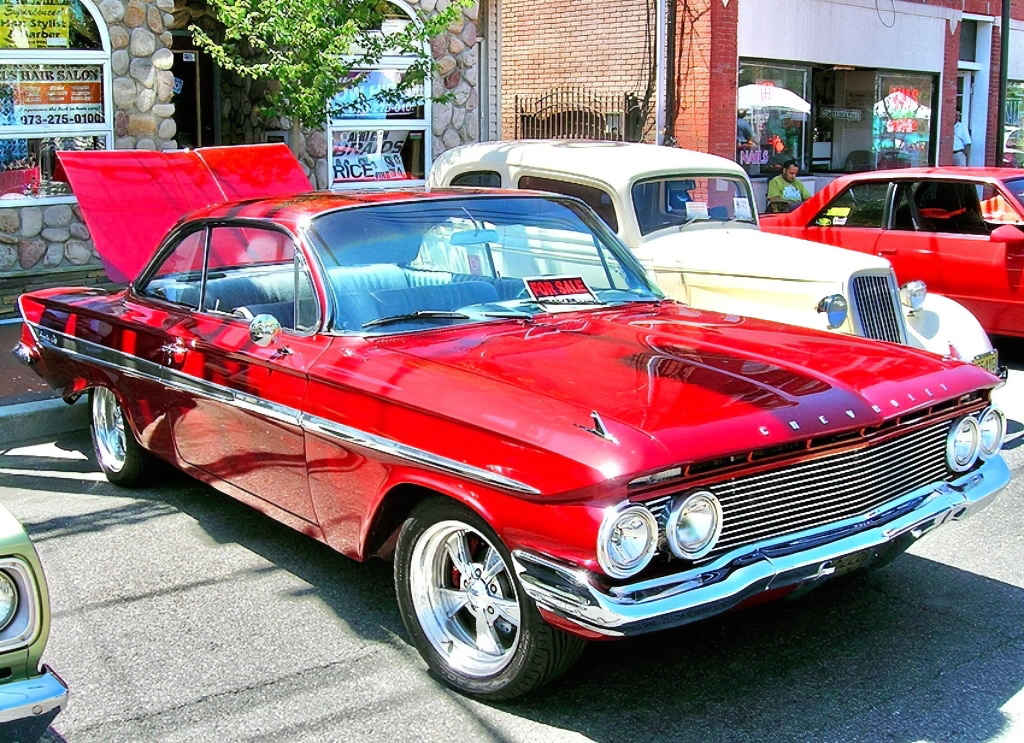 1961 Chevrolet Impala hardtop coupe equipped with aftermarket wheels.
